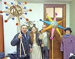 A group of people holding Christmas stars