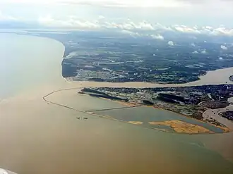End of Nandu river flowing around Xinbu Island (right) into Qiongzhou Strait (left)