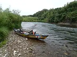 kayak on rocky beach next to river