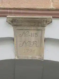 The keystone above the gate with the old and new cadastrel numbers No. 113 No. 79