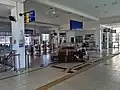 Station concourse above the platform area with the ticketing counter and the old wooden chairs which were previously used in the old Ipoh railway station.