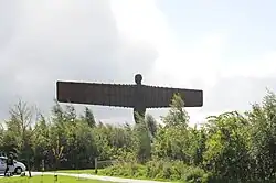Statue rising above tree line