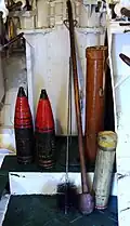 S.A.P. shells (left), cordite cartridge (lower right) and cartridge container (centre right) on HMS Belfast