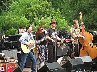 The band onstage at an outdoor concert in 2005