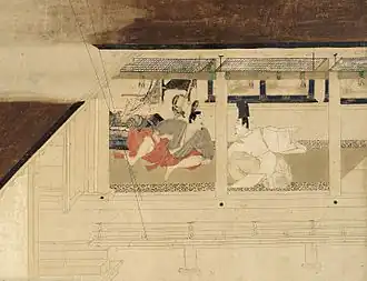 Two seated men face each other, seen through the wide openings of a veranda.