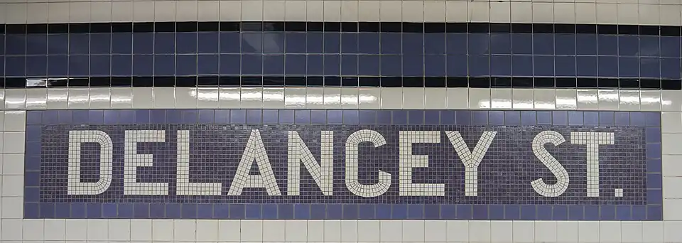 Original mosaic name tablet under renovated trim line