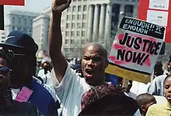 Protester Jonnie Jackson lifts a fist in the air