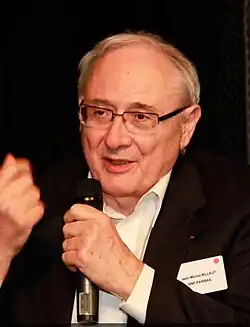 Billaut speaking into a microphone