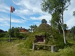 Goahti and flag in Mittådalen by the stream Mittån.