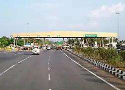 A road with cars stopped at a toll station