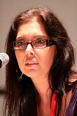 Soria at a microphone