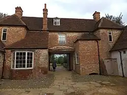 New Inn Farmhouse with outbuildings behind