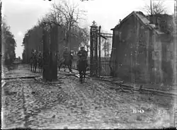 New Zealand Divisional Commander, Major General Russell, entering Le Quesnoy, France, on horseback, in the early morning after its capture during World War I.