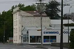 A rectangular four storey building on a street