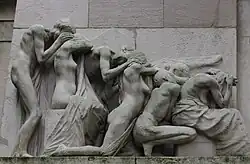 The group to the left of the tomb's entrance. All shield their faces from view. Note the perfect geometric line as their height reduces from the man standing to the far left to the seated woman on the far right.