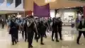 30 uniformed police officers wearing helmets walked into the mall and raised purple flags, accusing someone of violating national security law