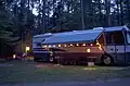 An motor home set up with party lights on the outside