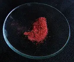 Red powder on a watch glass