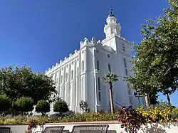 Gardens, benches, palm trees, and the front left corner (southeast) view of the St. George Utah Temple