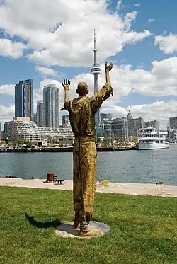 Migrants (bronze), 2007, Ireland Park, Toronto Harbourfront. The Jubilant Man stands 320 cm tall.