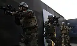 Students at SQT conduct a room clearing exercise.