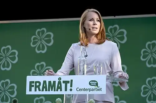 Annie Lööf speaking in front of a podium