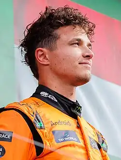 Lando Norris wearing orange racing overalls