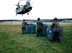 Members of 395 Air Despatch Troop preparing loads for lifting on a CH47 Chinook helicopter