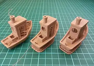 3DBenchys printed on a FFF 3D printer showing different faults caused by miscalibration