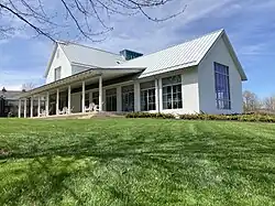 Building with a painted white facade over the red-brick exterior