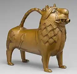 Aquamanile in the form of a lion, 12th century, made of copper alloy with glass inlays, overall: 19.5 x 21.9 x 8.7 cm, in the Metropolitan Museum of Art (New York City)