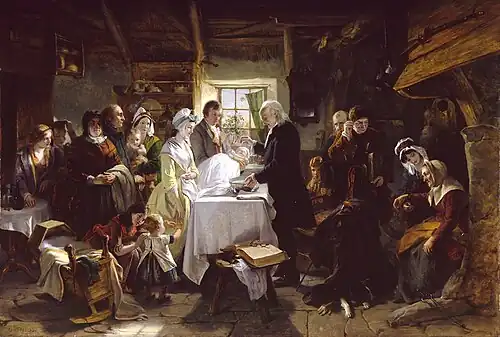A group gathered around a table where a minister sprinkles water on the head of an infant held by a man. Baptism in Scotland by John Phillip