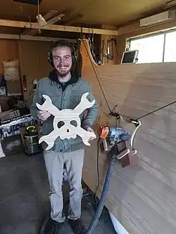 Bar Smith holding Hackaday symbol