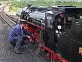 A driver oiling his engine at Dungeness