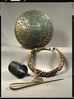 Bronze and gold votive items.