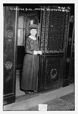 Female operator at an elevator door