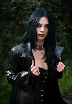 A young goth woman wearing a leather jacket