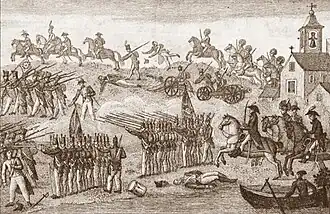 Sepia print shows soldiers in shakos and cocked hats marching and galloping from right to left. On the right is a church with a bell tower.