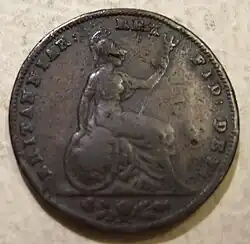 Copper coin of a seated woman Britannia