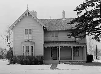 wooden slatted building, face-on, in snow