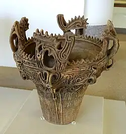 Ornately detailed clay pot in a museum
