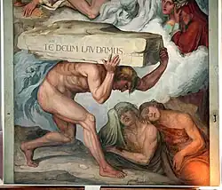 A painting of a man carrying a large stone with the phrase "Te Deum Lavdamus" carved into it on his back
