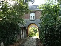 Gothic pointed arch door with bevel profile in the sandstone ground floor (Kortenberg)