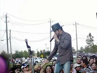 La Mafia's Oscar de la Rosa shaking hands with fans at a concert