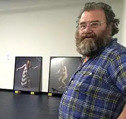 Robert Leonard setting up the exhibition 'Yvonne Todd: Creamy Psychology', 2014