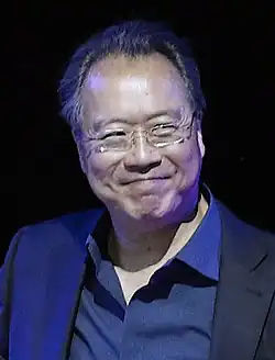 A man wearing glasses and smiling.