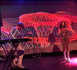 Both members of Magdalena Bay performing at a concert