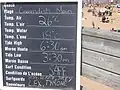 Board with daily conditions at main entrance to beach