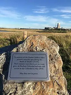 A photograph of a plaque at Dunbar, commemorating the Scottish prisoners who were buried in a mass grave at Durham