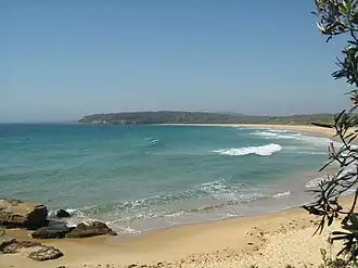View of a beach, bay and distant headland